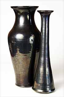 Two tall black vases